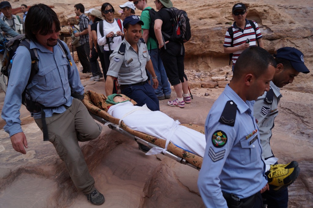 A tourist collapses near the top of the stairs to the monastery at Petra, in Jordan. (photo by Kirsten Koza)