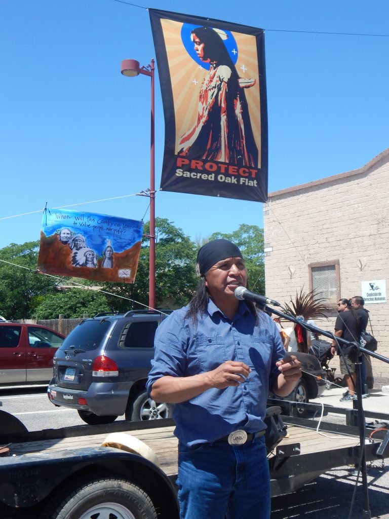 San Carlos Apache Vice Chairman Tao Etpison spoke to those gathered at the Oak Flat Street Fair on April 19. (Photo by Sandra Rambler)