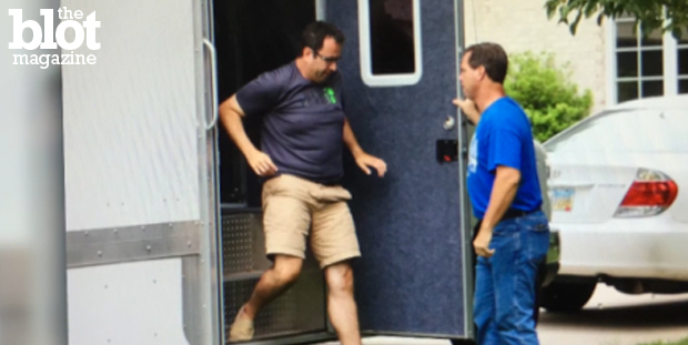 Subway spokesperson Jared Fogle's home was raided Tuesday two months after the former director of his charity was arrested on child porn charges. Fogle is seen above at his home during Tuesday's investigation. (Screen capture from usatoday.com)